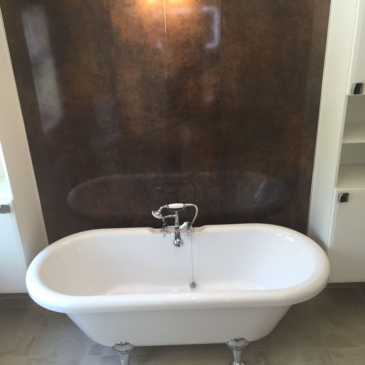 Freestanding roll-top bath with chrome mixer, fitted by P.D. Powell & Sons