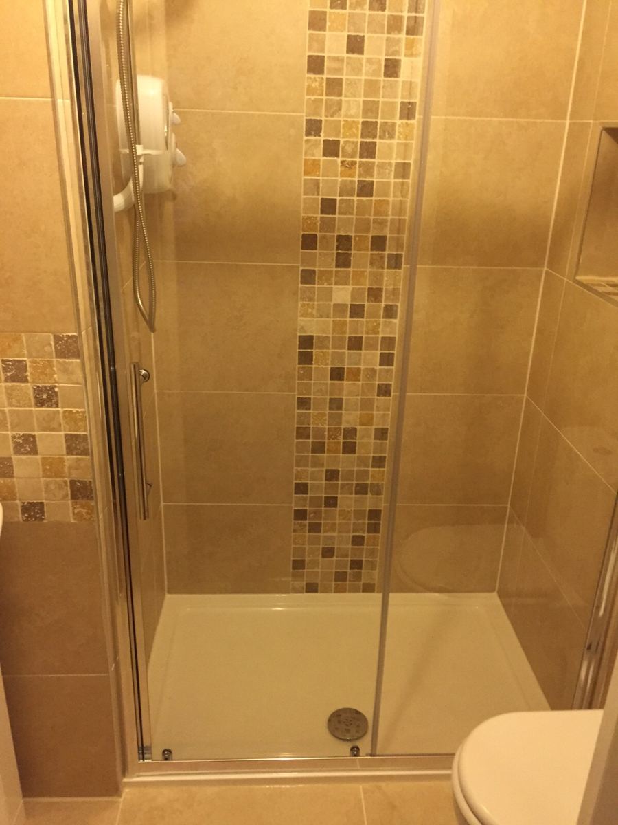 Walk-in shower with mosaic feature strip