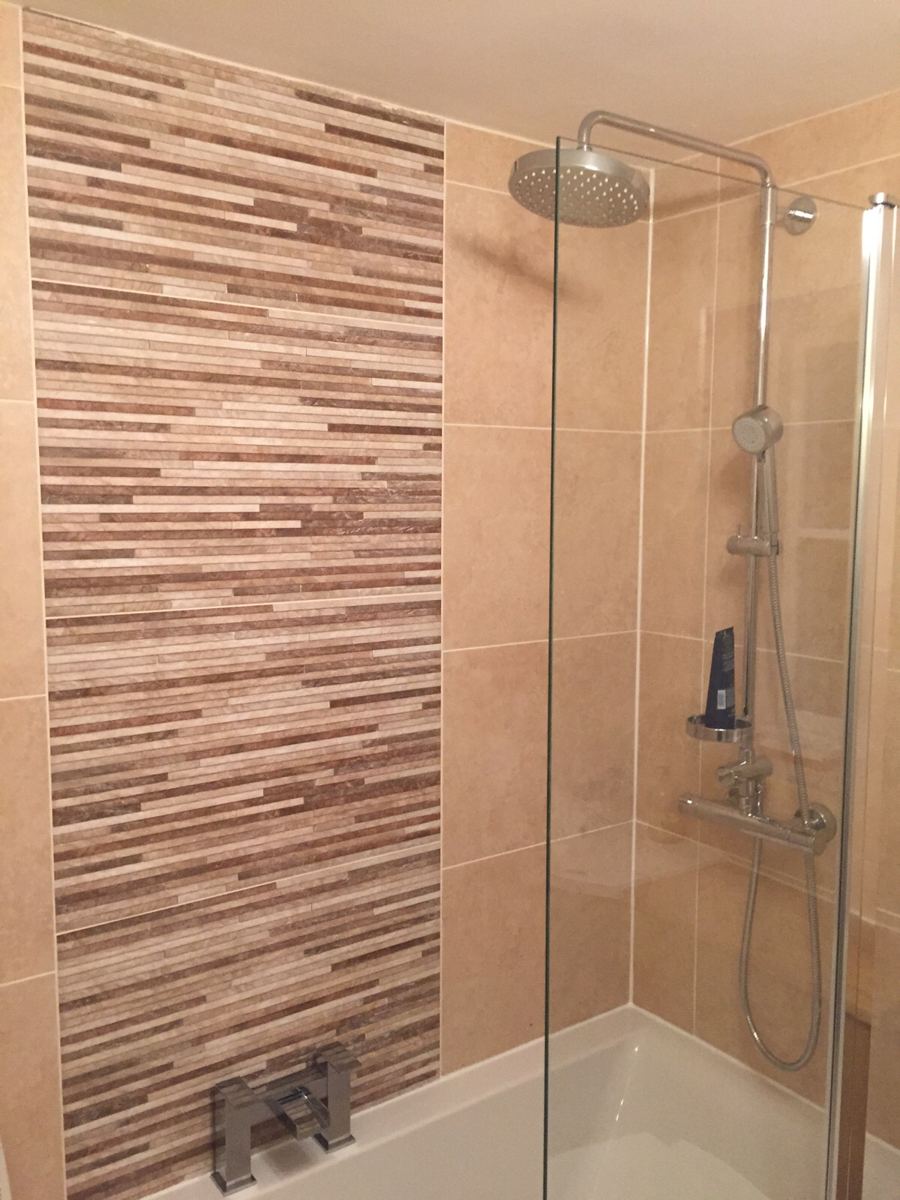 Bath with glass screen and feature tiles fitted by P.D. Powell & Sons